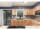 Modern kitchen boasting granite counters, wood cabinets, and a stylish backsplash at 4917 S Xenophon Way, Morrison, CO 80465
