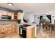 Open kitchen boasts granite countertops and seamlessly connects to the dining area at 4917 S Xenophon Way, Morrison, CO 80465