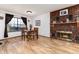 Cozy dining area with brick fireplace, hardwood floors, and natural lighting at 4917 S Xenophon Way, Morrison, CO 80465