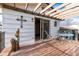 Cozy patio with light wood pergola and decorative wooden art piece beside an outdoor seating area at 4917 S Xenophon Way, Morrison, CO 80465