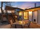 Cozy backyard patio with table, chairs, deck and sliding glass door access to home at 4917 S Xenophon Way, Morrison, CO 80465