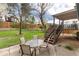 Inviting patio with table and chairs, ideal for outdoor dining and entertaining near lush backyard at 4917 S Xenophon Way, Morrison, CO 80465