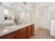 Bathroom with double sinks, a large mirror, and tile floors at 12997 Wyandot Way, Westminster, CO 80234