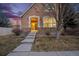 Charming stucco home featuring a brick facade, arched entryway, and landscaped front yard at 12997 Wyandot Way, Westminster, CO 80234
