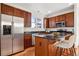 Well-equipped kitchen featuring stainless steel appliances, dark cabinets and a central island with bar seating at 12997 Wyandot Way, Westminster, CO 80234