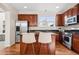 Modern kitchen with stainless steel appliances, dark cabinets, granite countertops and island seating at 12997 Wyandot Way, Westminster, CO 80234