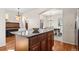 Open kitchen with a large island, wood floors, and a view into the dining room at 12997 Wyandot Way, Westminster, CO 80234