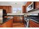A spacious kitchen with granite countertops, stainless steel appliances, and wood cabinets at 12997 Wyandot Way, Westminster, CO 80234