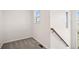 Upper landing area with hardwood railing and adjacent to carpeted bonus room at 12997 Wyandot Way, Westminster, CO 80234