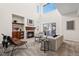 Bright living room with a cozy fireplace, high ceilings and sliding glass doors to the backyard at 12997 Wyandot Way, Westminster, CO 80234