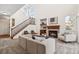 Spacious living room with a cozy fireplace, staircase access and ample natural light at 12997 Wyandot Way, Westminster, CO 80234