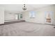 Spacious living room featuring new carpet, large windows with natural light, and a walk-out door at 12997 Wyandot Way, Westminster, CO 80234
