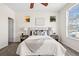Bright bedroom with a large window, side tables with lamps, and neutral colored decor at 12997 Wyandot Way, Westminster, CO 80234