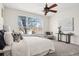 Bright bedroom with a large window, sitting area, and neutral colored decor at 12997 Wyandot Way, Westminster, CO 80234