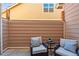 Cozy patio with two cushioned chairs and a small table at 12997 Wyandot Way, Westminster, CO 80234