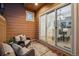 Covered patio with cushioned chairs and a sliding door that looks into the dining room at 12997 Wyandot Way, Westminster, CO 80234