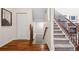 Staircase with hardwood floors, closet, railing, and carpeted stairs at 12997 Wyandot Way, Westminster, CO 80234