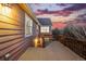 Back deck with wood planks, metal railing and view of the sky at dusk at 12997 Wyandot Way, Westminster, CO 80234