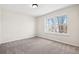 Cozy bedroom featuring neutral colored walls and flooring and large window at 12997 Wyandot Way, Westminster, CO 80234