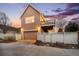Exterior view of home with garage, deck, and white picket fence in a suburban neighborhood at 12997 Wyandot Way, Westminster, CO 80234