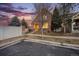 Charming home exterior with a freshly painted facade, highlighted by mature trees, professional landscaping, and warm lighting at 12997 Wyandot Way, Westminster, CO 80234
