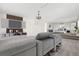 Spacious living room open to bedroom with TV, modern shelving, and comfortable seating at 12997 Wyandot Way, Westminster, CO 80234