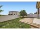 Landscaped backyard features a small patio, green grass and an updated vinyl fence for added privacy at 3572 Lissa Dr, Berthoud, CO 80513