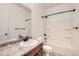 Well-lit bathroom showcasing a sleek vanity, modern sink, and shower-tub combination with dark fixtures at 3572 Lissa Dr, Berthoud, CO 80513