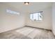 The bedroom is brightly lit by a big window and a smaller stained glass window at 3572 Lissa Dr, Berthoud, CO 80513