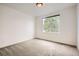 Bright bedroom with neutral carpet, a modern ceiling light, and a large window overlooking a green view at 3572 Lissa Dr, Berthoud, CO 80513