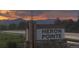 A picturesque view of the Heron Pointe community sign, set against a stunning sunset and mountain backdrop at 3572 Lissa Dr, Berthoud, CO 80513