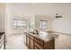 A spacious kitchen features an island, stainless steel appliances, and wooden cabinets at 3572 Lissa Dr, Berthoud, CO 80513