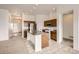 A spacious kitchen boasts a center island, stainless steel appliances, wooden cabinets, and neutral walls at 3572 Lissa Dr, Berthoud, CO 80513
