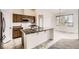 Kitchen features an island, an oven, wooden cabinets, and neutral walls at 3572 Lissa Dr, Berthoud, CO 80513