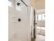 Bright shower featuring a modern shower head, sleek white surround, and well-placed shelving for bathroom essentials at 3572 Lissa Dr, Berthoud, CO 80513