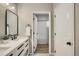 Stylish bathroom featuring a double vanity, modern fixtures, and access to a shower-tub combo at 3912 S Carson St # 204, Aurora, CO 80014
