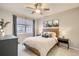 Cozy bedroom features a large window, neutral decor, and a ceiling fan at 3912 S Carson St # 204, Aurora, CO 80014