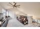 Open concept bonus room with vaulted ceilings, a ceiling fan, and plush carpet flooring at 3912 S Carson St # 204, Aurora, CO 80014