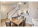 Dining room with wooden table and seating for six, open to kitchen and staircase at 3912 S Carson St # 204, Aurora, CO 80014