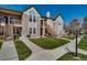 Attractive condo exterior with stone accents, a well-maintained lawn, and private outdoor entrances at 3912 S Carson St # 204, Aurora, CO 80014