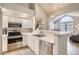 Beautiful kitchen featuring modern appliances, white cabinets, and an open concept design at 3912 S Carson St # 204, Aurora, CO 80014