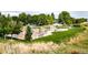 Community playground with modern play equipment, benches, and picnic tables surrounded by green grass at 3912 S Carson St # 204, Aurora, CO 80014