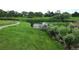 Scenic community pond surrounded by vibrant green grass and foliage, creating a peaceful environment at 3912 S Carson St # 204, Aurora, CO 80014