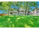 Expansive backyard with green lawn and mature trees, offering a serene outdoor space at 5543 S Kenton Ct, Englewood, CO 80111
