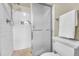 White tiled shower with glass door at 5543 S Kenton Ct, Englewood, CO 80111