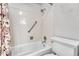 Bathtub and shower combination featuring neutral-toned tiles at 5543 S Kenton Ct, Englewood, CO 80111