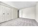Neutral bedroom features plush carpeting and a double closet with decorative hardware at 5543 S Kenton Ct, Englewood, CO 80111