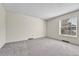 Bright bedroom with plush neutral carpeting with a large window providing ample natural light at 5543 S Kenton Ct, Englewood, CO 80111
