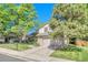 Lovely home has mature landscaping, stone accents, a front lawn and an attached two-car garage at 5543 S Kenton Ct, Englewood, CO 80111