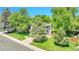 A charming home nestled among mature trees, with a well-manicured lawn and inviting curb appeal at 5543 S Kenton Ct, Englewood, CO 80111
